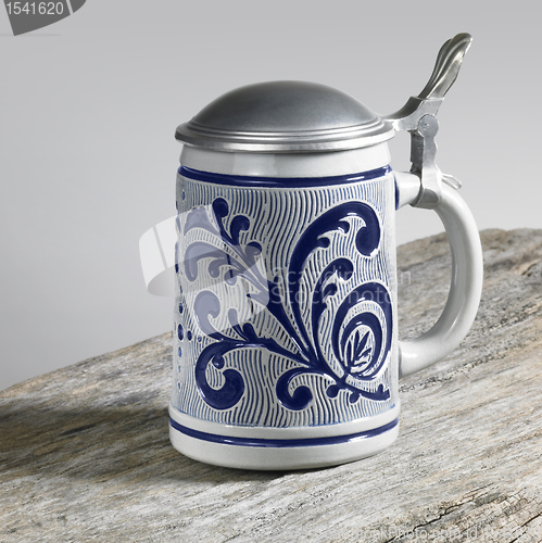 Image of blue decorated stein on wooden surface