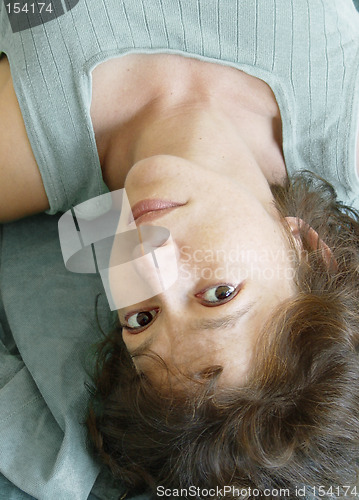 Image of Attractive woman lying upside down