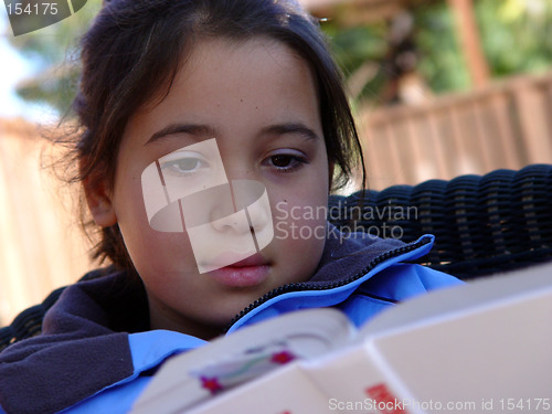 Image of Cute girl reading a book