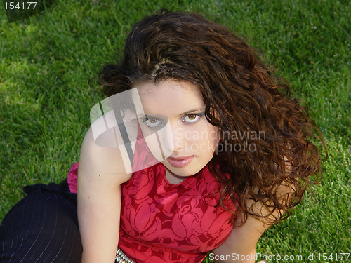 Image of Beautiful girl sitting on the grass
