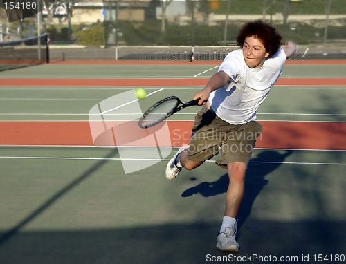 Image of Teenage boy playing tennis