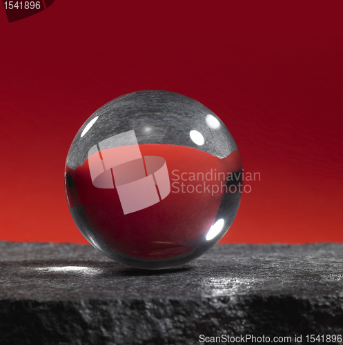 Image of crystal ball on stone surface