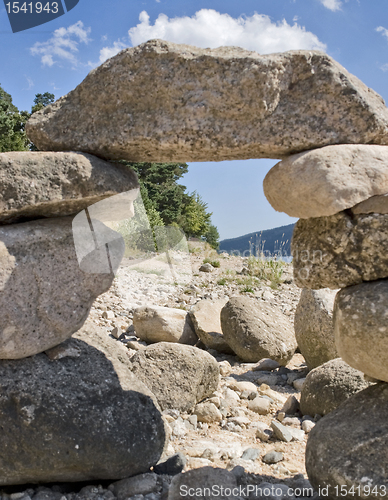 Image of sunny illuminated pebble archway