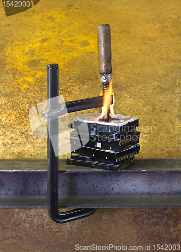 Image of burning vise and hard disks