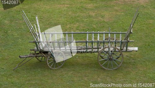 Image of historic hayrack in green grassland