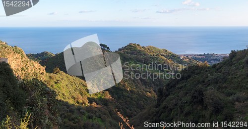 Image of Mediterranean hills near the sea coast at sunset 