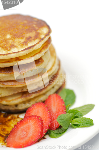 Image of Pancake Fritters with strawberry and leaflets of mint