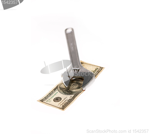 Image of wrench and dollar bill isolated on white