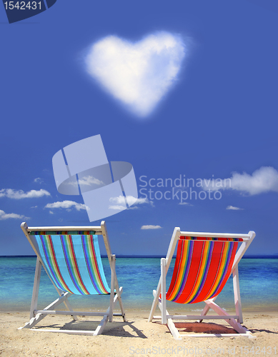 Image of stripy chairs on the beach 