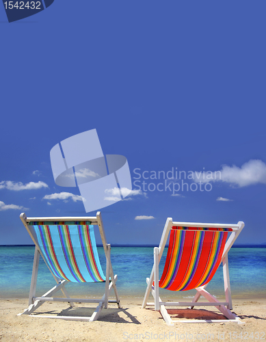 Image of stripy chairs on the beach 