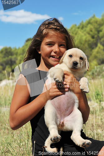 Image of puppy labrador and smiling girl