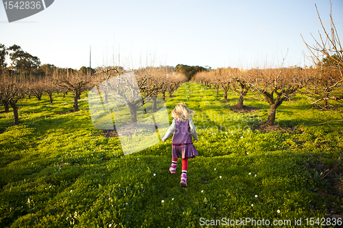 Image of Little girl running outdoors