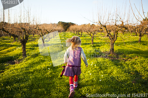 Image of Little girl running outdoors