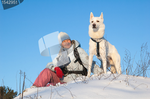 Image of The woman with a dog in winter on walk