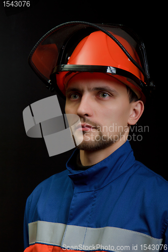 Image of The worker in overalls and a helmet