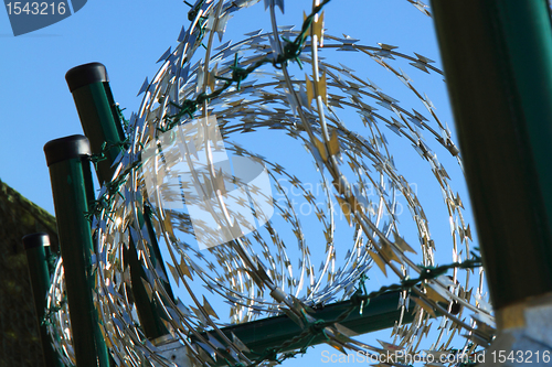 Image of barbed wire against blue sky