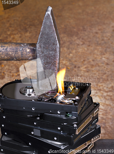 Image of hammer on stack of hard disk