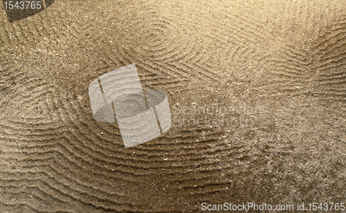 Image of abstract owl in brown sand