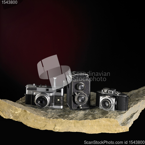 Image of nostalgic cameras on stone surface