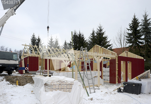 Image of wooden house construction at winter time