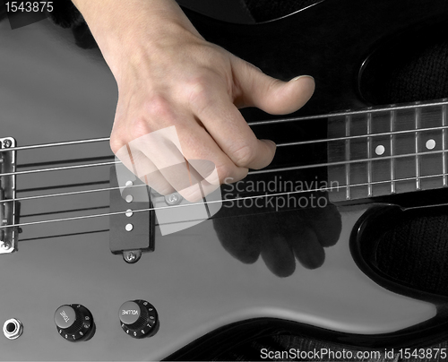 Image of hand and electric bass