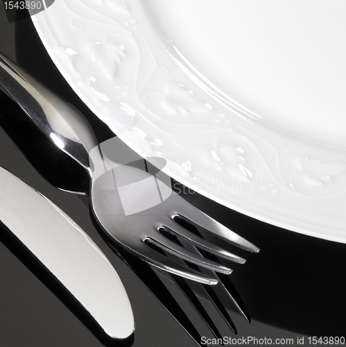 Image of porcelain dinnerware with fork and knife