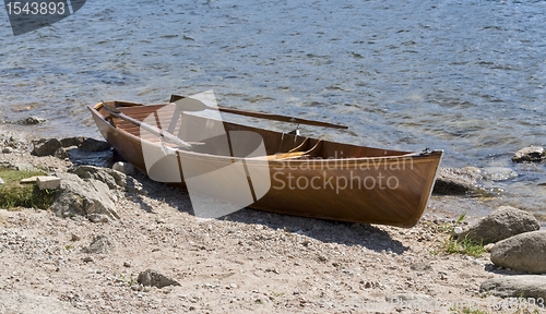 Image of wooden rowboat waterside