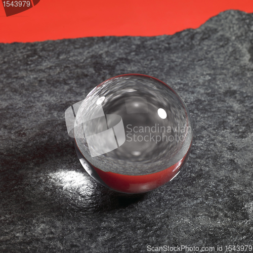 Image of crystal ball on stone surface