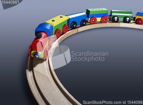 Image of colorful wooden toy train on tracks