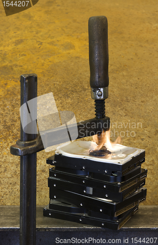 Image of burning vise and hard disks