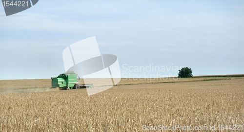 Image of harvester in a crop field
