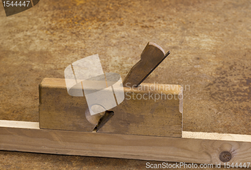 Image of planer on wooden plank