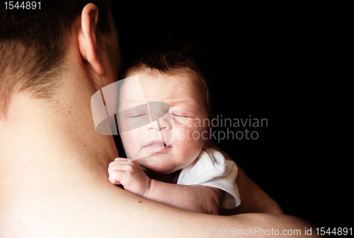 Image of infant in the arms of his father