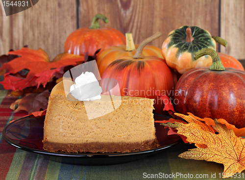 Image of Pumpkin cheesecake in autumn setting