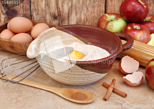 Image of Baking ingredients including flour, apples and supplies.
