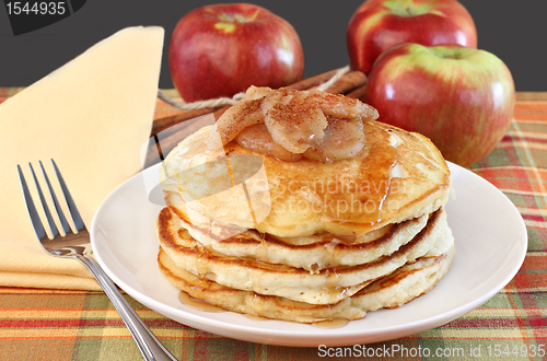 Image of Stacked pancakes with baked apples topping.