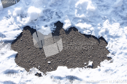 Image of Asphalt between snow drifts