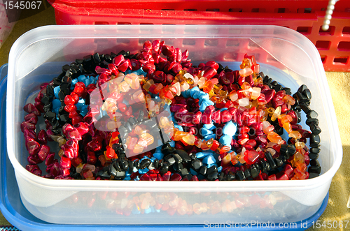 Image of Plastic box loaded with colorful jewelry beads 
