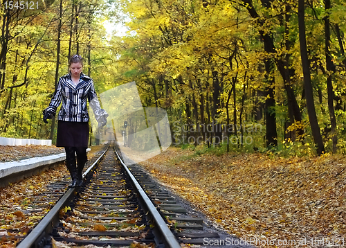 Image of Young women walking on rails
