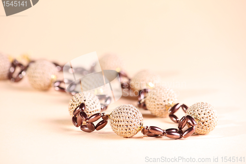 Image of Brown beads at pink background