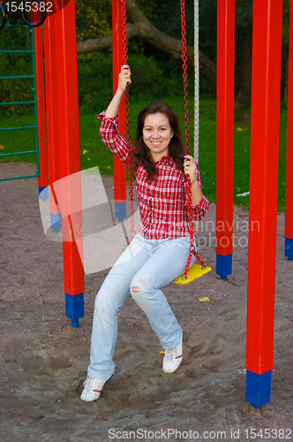 Image of happy young woman on playground