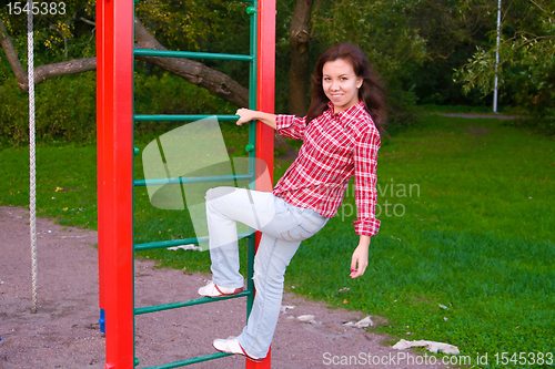 Image of happy young woman on playground
