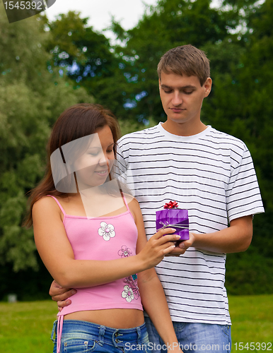 Image of Young Man Giving Present To Girlfriend