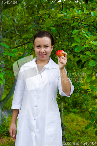 Image of Happy smiling doctor with apple