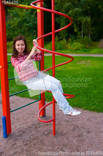 Image of happy young woman on playground