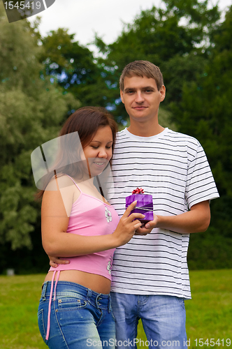 Image of Young Man Giving Present To Girlfriend