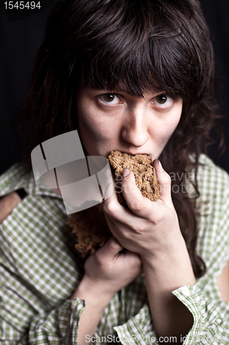 Image of beggar woman eating bread