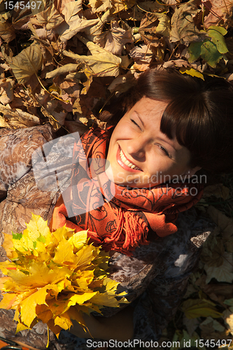 Image of woman with autumn leaves
