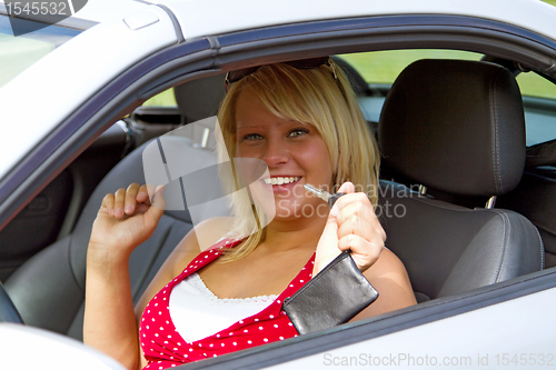 Image of Young woman happy about her new drivers license