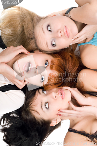 Image of Three amazed women touching their cheeks